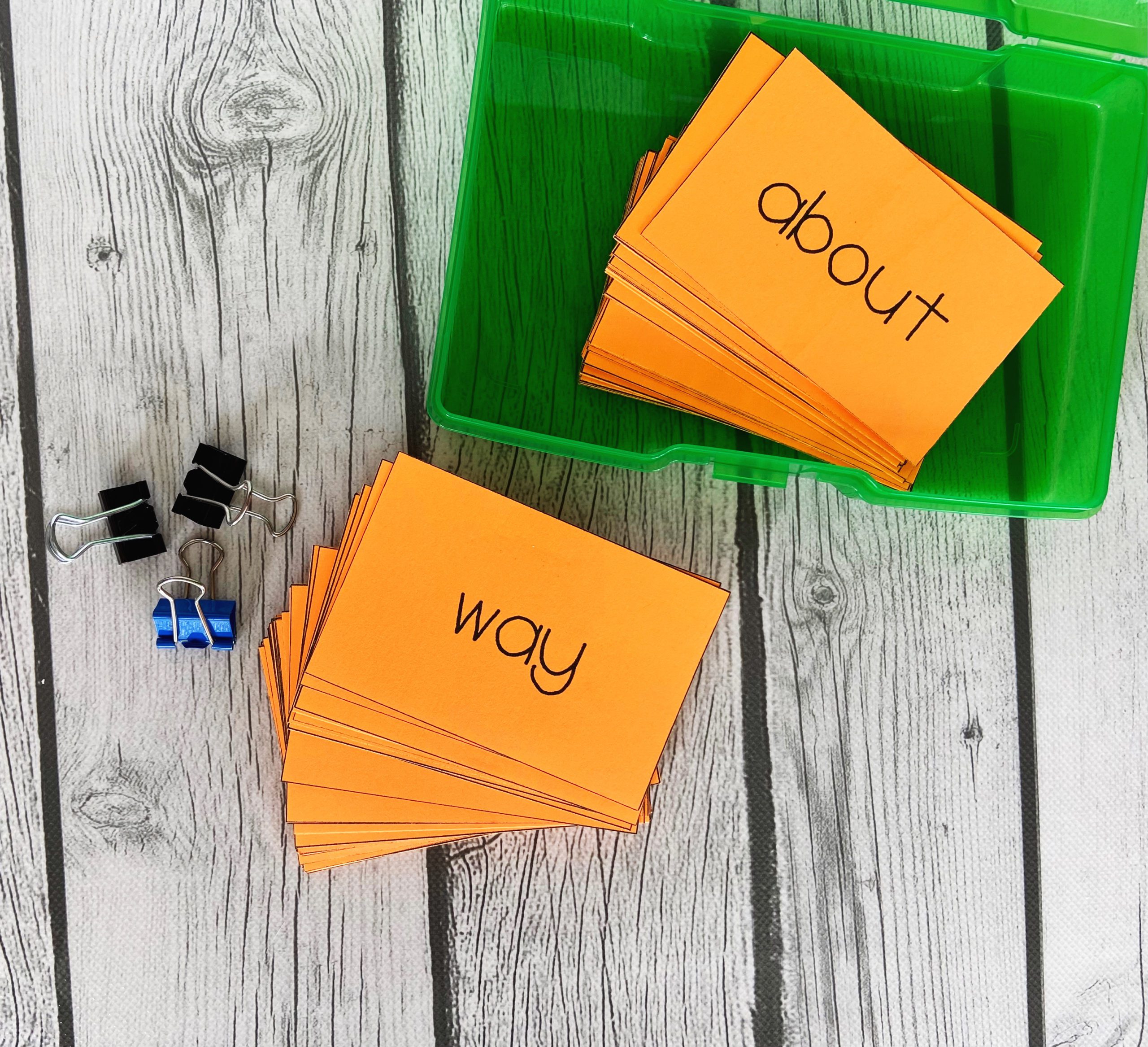 orange flashcards with the words "way" and "about" on then to show that they are high-frequency words.